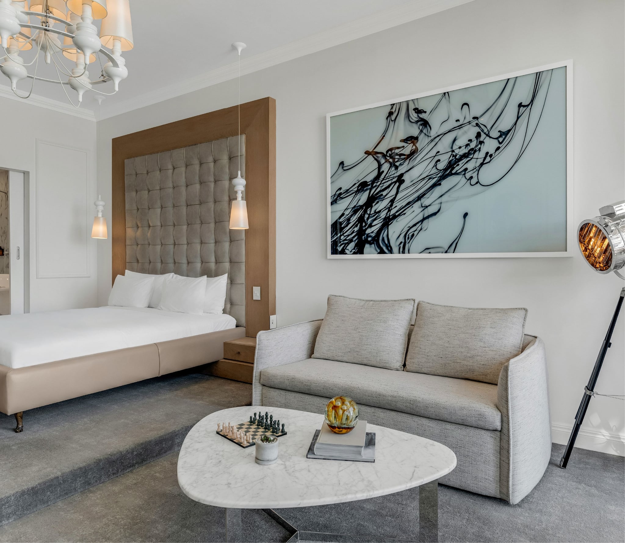 Superior Sea-Facing Suite open-plan layout with bedroom, seating area and long marble-topped console