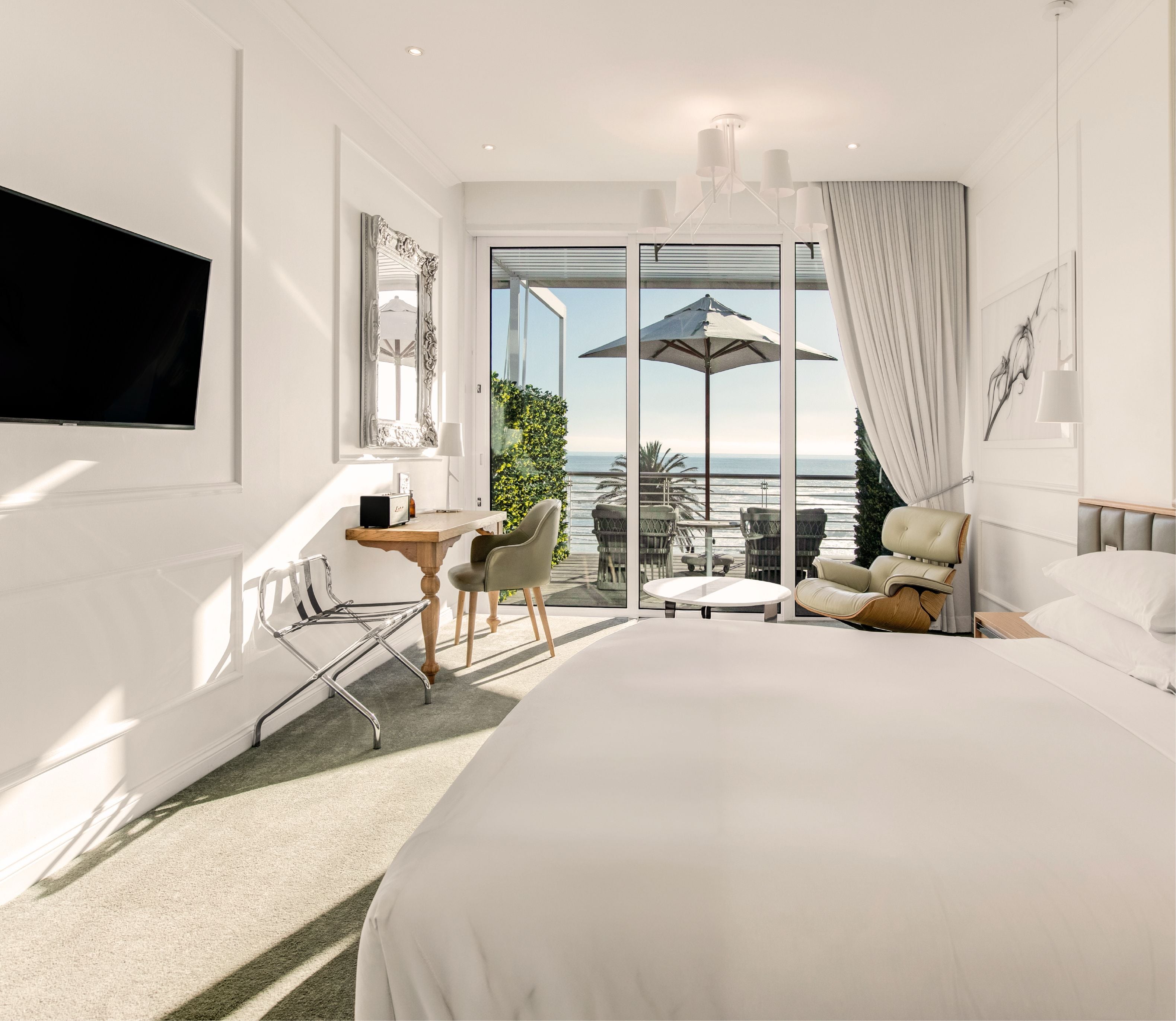 Studio Sea-Facing Room bed and desk area overlooking the ocean terrace at The Marly